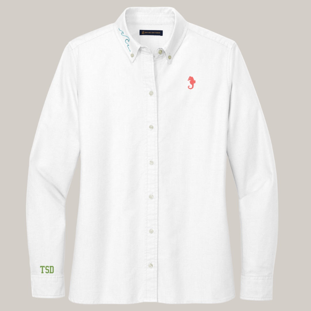 White shirt with embroidered designs on a gray background