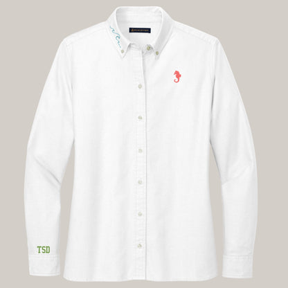 White shirt with embroidered designs on a gray background