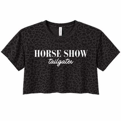 A black cropped t-shirt with a subtle leopard print pattern, featuring the text 'HORSE SHOW' in a bold serif font and 'tailgater' in a white cursive script, displayed on a solid white background.