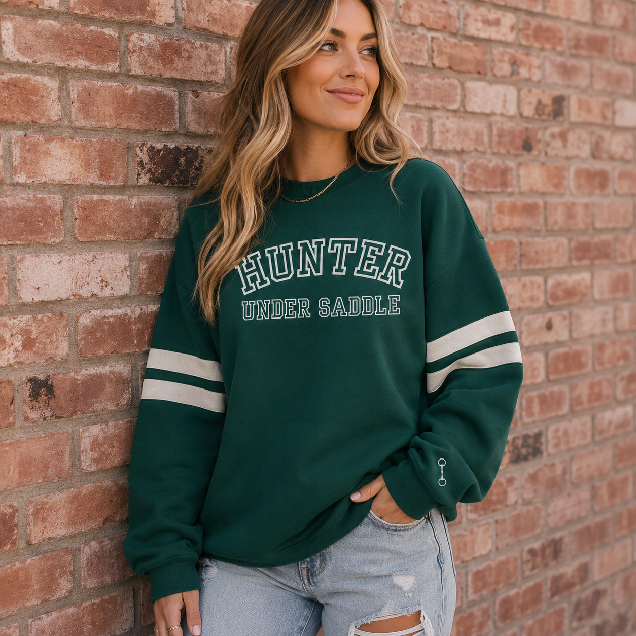 Varsity style crewneck sweatshirt on a horse girl with HUNTER UNDER SADDLE printed on the front