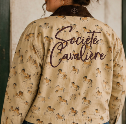 A person shown from the back wearing a beige jacket with an allover horse print and a dark brown collar. The back of the jacket features the embroidered words 'Société Cavaliere' in dark brown script, and a small crest logo is visible near the collar.