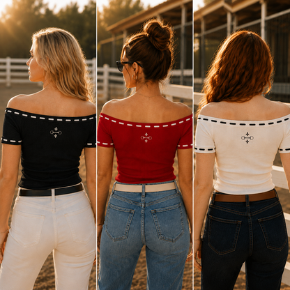 Three women shown from the back wearing off-the-shoulder short-sleeve tops in black, red, and white, each paired with jeans. The tops have white or black dashed trim along the neckline and a small embroidered cross-like logo at the center back.